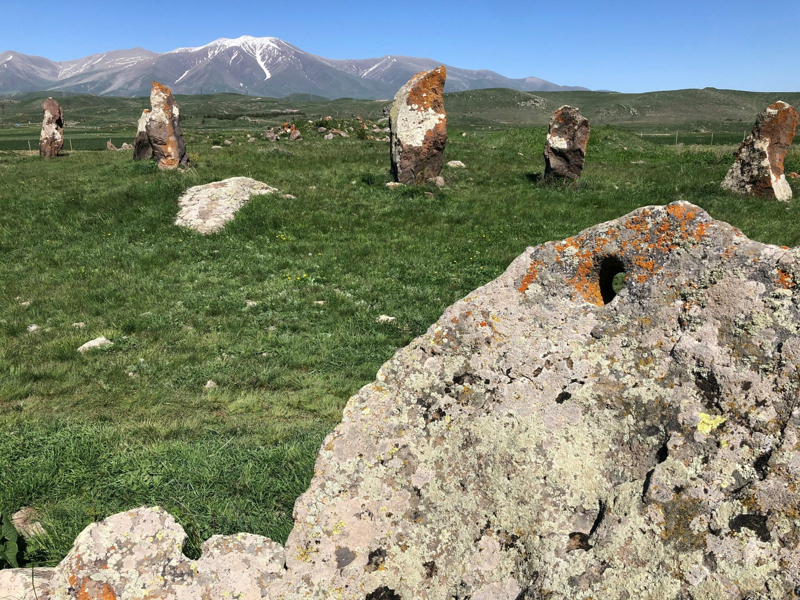 gray rock formation on green grass field during daytime